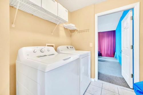 a laundry room with a washer and dryer at Near Disney 7BR Home - Pool Hot Tub Games Room in Kissimmee