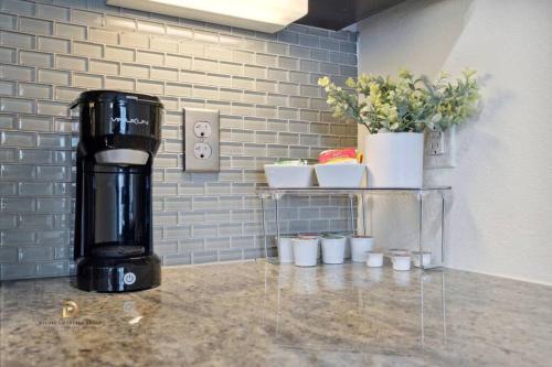 a coffee maker sitting on a counter in a room at Houston Med Center Luxury King Suite with Free Parking in Houston