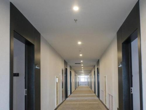 a hallway of a building with a long corridor at Green Tree Inn Liaoning Panjin Wanda Plaza Tianjia in Panjin