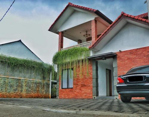 De Jati House في Cibening Empat: ركن السيارة أمام المنزل