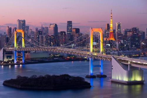a bridge over the water with a city in the background at HOSTEL LUND I -Oimachi- in Tokyo