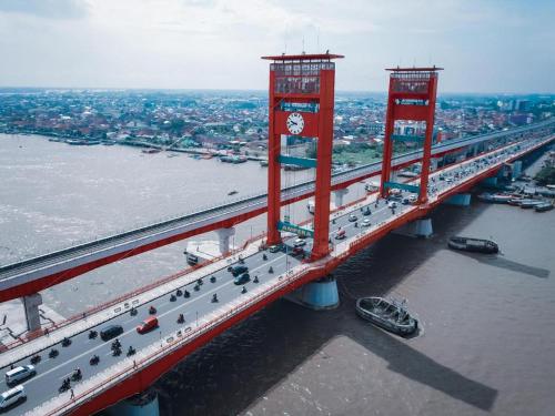 an aerial view of a bridge with a clock on it at KR Hotel in Palembang