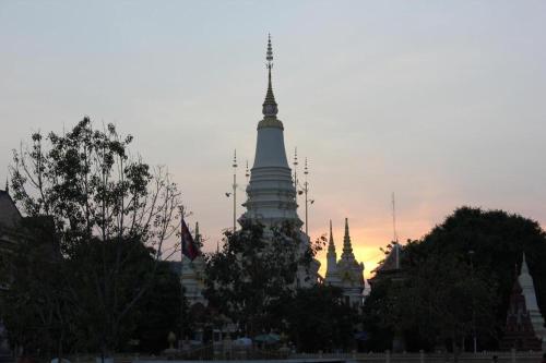 a view of a pagoda in a city at sunset at Unique Hotel in Phnom Penh