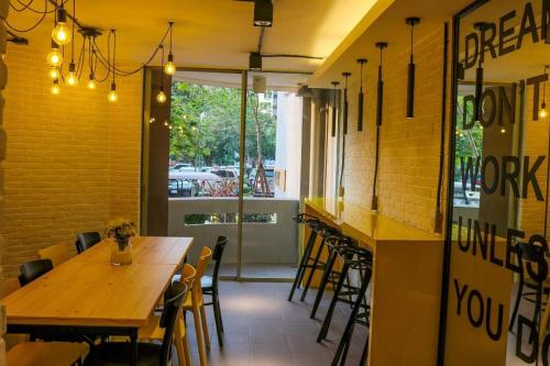a restaurant with tables and chairs and a window at DLUXX THAMMASAT in Ban Bang Phut (3)