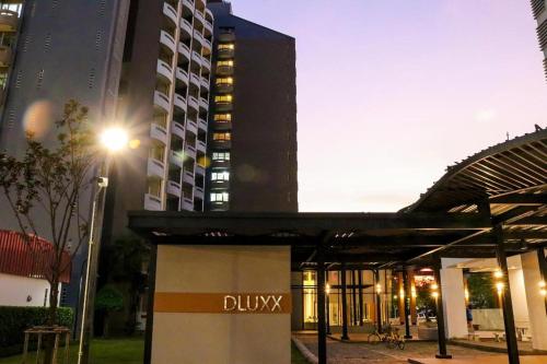 a building with a bulvy sign in front of it at DLUXX THAMMASAT in Ban Bang Phut (3)