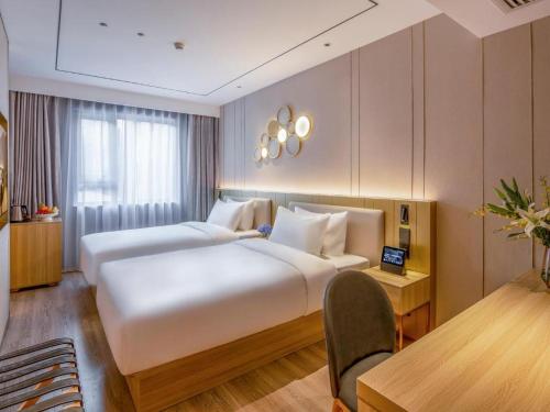 Gulta vai gultas numurā naktsmītnē Orange Hotel Beijing Zhongguancun Tsinghua University