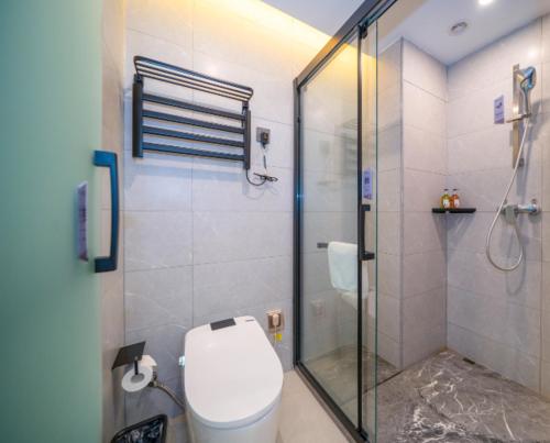 e bagno con servizi igienici e doccia in vetro. di Borrman Hotel Zhangzhou Baolong Plaza a Zhangzhou