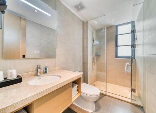 a bathroom with a toilet and a sink and a shower at City Comfort Inn Hotel Taizhou Jiangyan 2nd Affiliated Middle School Railway Station in Guanzhuang