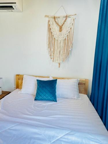a bedroom with a bed with blue curtains at Vile Villa Homestay View Biển 01 Đảo Phú Quý in Cu Lao Thu
