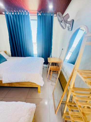 a room with two beds and a mirror at Vile Villa Homestay View Biển 01 Đảo Phú Quý in Cu Lao Thu