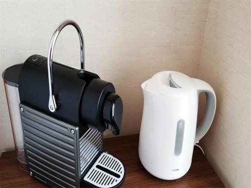 a blender and a tea kettle on a table at Hotel & Onsen 2307 Shiga Kogen in Shiga Kogen