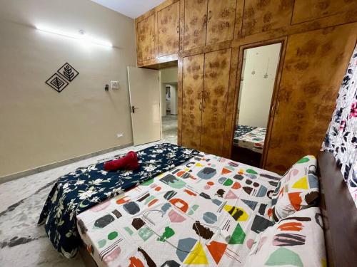 a bedroom with a bed with a quilt on it at Beautiful 3bhk at Hitechcity in Kondapur