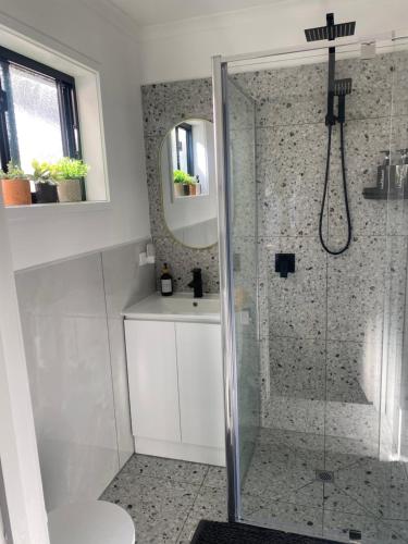 a bathroom with a shower with a toilet and a sink at Ange's BnB - Self Contained Unit with Ensuite in Lyndhurst