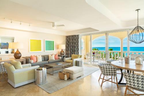 a living room with a couch and a table at Grace Bay Club in Grace Bay