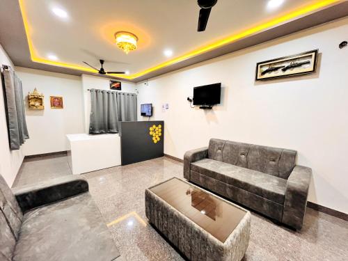 a living room with a couch and a tv at Hotel Kutch Palace in Bhuj