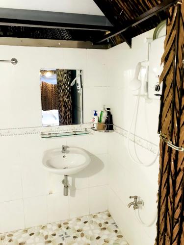 a bathroom with a sink and a mirror at Hometravel Mekong Can Tho in Can Tho