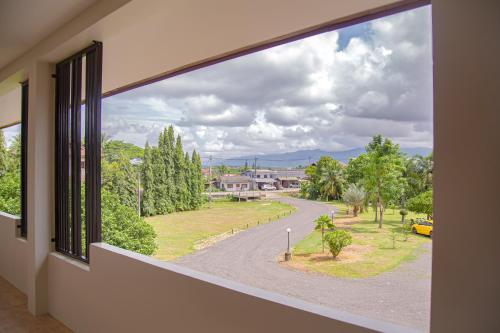 a window in a building with a view of a street at น่าน ม่วนใจ Nan Muanjai Hotel in Pua