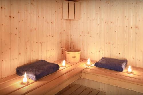 two beds in a sauna with candles in it at Chalet L'Ours Blanc - OVO Network in Le Grand-Bornand