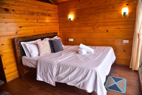 a bedroom with a bed in a wooden room at INAS OCEAN FRONT in Canacona