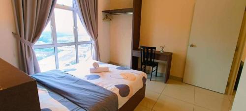 a bedroom with a bed and a desk and a window at Kulai d'putra suites beside ioiMall near Airport and JPO in Kulai