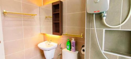 a small bathroom with a sink and a toilet at Kulai d'putra suites beside ioiMall near Airport and JPO in Kulai