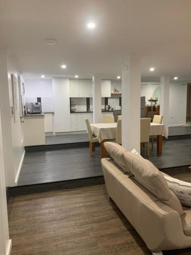 a living room with a couch and a dining room at Ocean Park Retreat in Yeppoon
