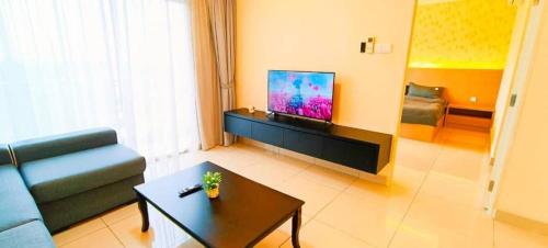 a living room with a couch and a tv at Kulai d'putra suites beside ioiMall near Airport and JPO in Kulai