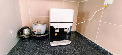 a coffee maker sitting on a counter in a kitchen at Kulai d'putra suites beside ioiMall near Airport and JPO in Kulai