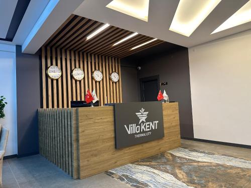 a view of a lobby with a visitoragent counter and clocks at Villa Kent Termal Otel in Gazligol