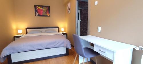 a bedroom with a desk and a bed and a desk at Apartament Downtown Cluj-Napoca in Cluj-Napoca