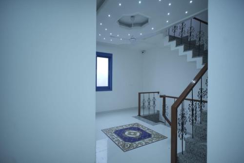 a staircase in a house with blue lights at The Host in Amritsar