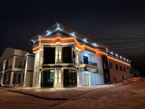 a large building with lights on it at night at Villa Kent Termal Otel in Gazligol