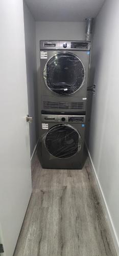 two microwaves stacked on top of each other in a room at Cozy One bedroom BSMT Apartment in Edmonton