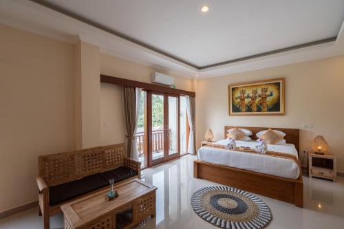 a bedroom with a bed and a large window at Oka Suite Sebatu Ubud in Tampaksiring
