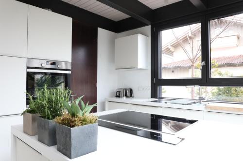 a kitchen with white counters and a large window at Residence in Chieming