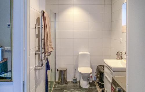 a bathroom with a toilet and a sink at Lovely Home In Blid With Kitchen in Blidö