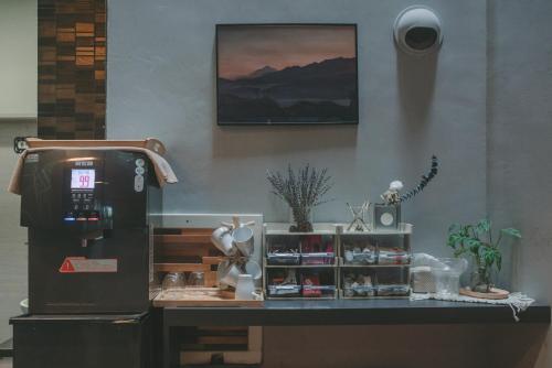 a coffee shop with a counter with a coffee machine at Coral B&B in Xiaoliuqiu