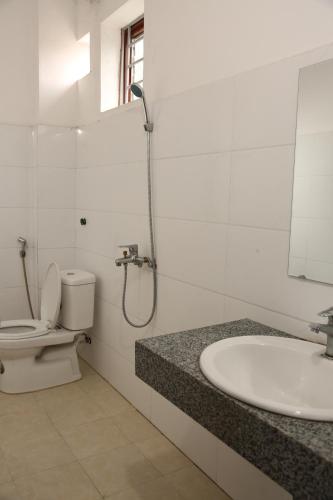 a bathroom with a toilet and a sink and a shower at Khu du Lịch Trải nghiệm Gốm Phù Lãng in Bắc Ninh