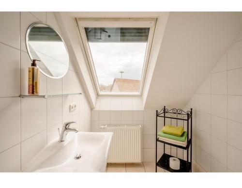 a bathroom with a sink and a window at Hirschen Apartments in Oberreute