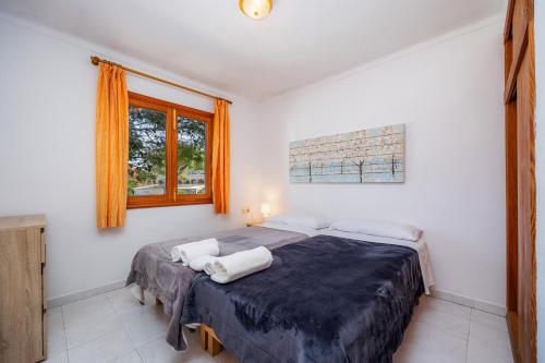 a bedroom with a bed with two pillows on it at Apartamento mhm 5 in Cala Ratjada