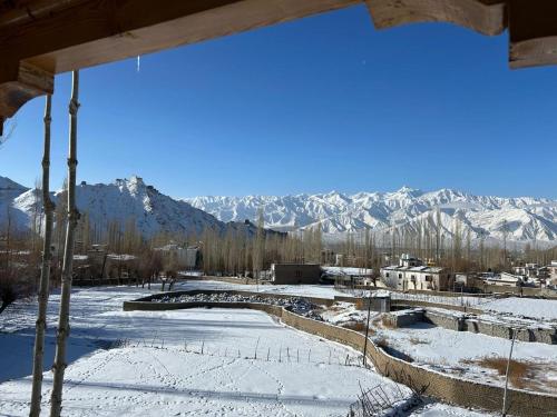 a view of a snow covered valley with mountains at The Morning Sky hotel in Leh