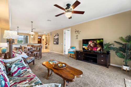 a living room with a couch and a flat screen tv at Waikoloa Beach Villas F22 condo in Waikoloa
