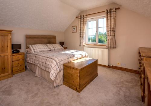 a bedroom with a large bed and a window at Llecyn in Pwllheli