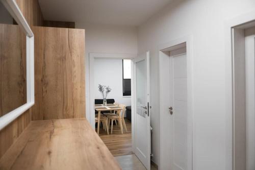 a room with a hallway with a table and a door at Ubytování v Beskydech - Apartmán Patrik in Čeladná