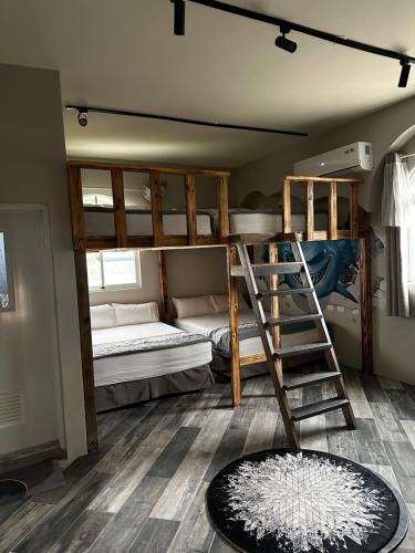 a room with two bunk beds and a ladder at Ludao 38 Degree Ocean view B&B in Green Island