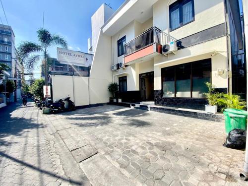 an empty street in front of a building at Ayuri Hotel Malioboro in Sentool