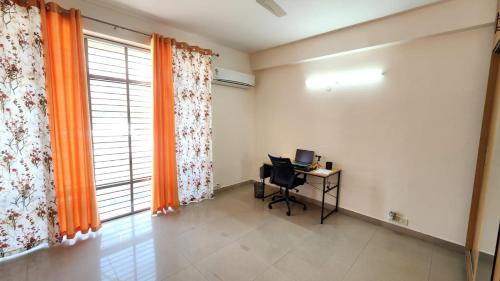 a room with a desk with a computer and a window at Rustic Homestay Sonipat in Sonīpat