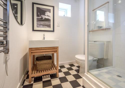 a bathroom with a sink and a toilet at St Tudwals View in Abersoch