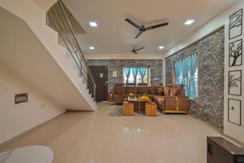 a living room with a couch and a table at ll EMPYREAN STAY ll AIRAWAT VILLA ll 2BHK ll AC ll PVT POOL ll LUXURY VILLA ll in Lonavala