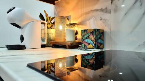 a shelf with vases and a lamp on a wall at Top floor apartment in central Buxton in Buxton